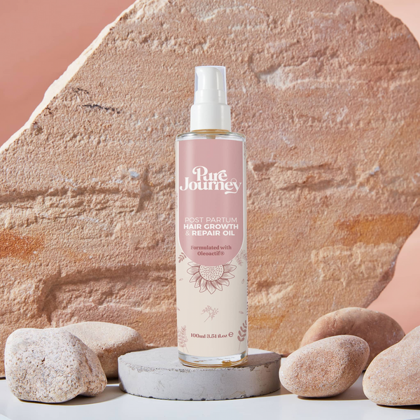 Pure Journey postpartum hair growth oil natural lifestyle shot with organic textures and warm lighting